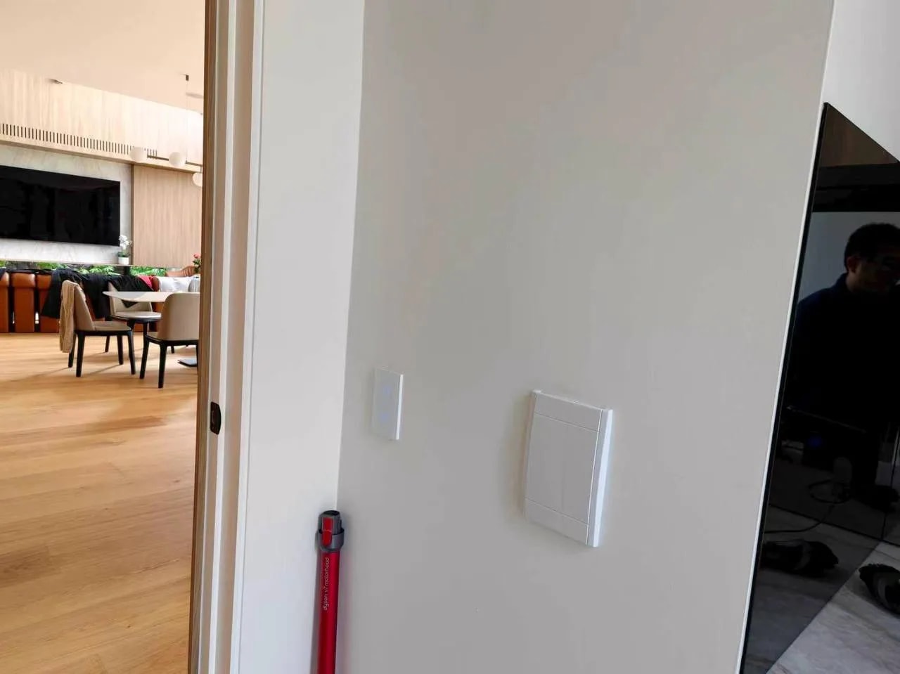 White smart lighting controls on a pale wall in an open-plan Kew living area